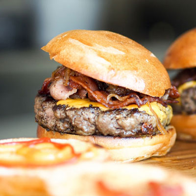 close-up of open buns and bacon cheeseburgers