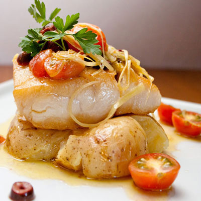 close-up of fish filet on top of potatoes