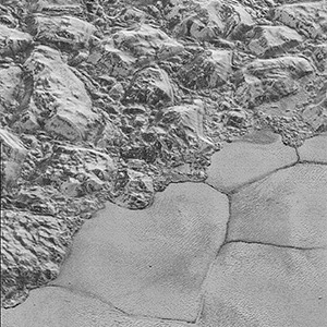 Mountains of ice along a portion of smoother ice planes on Pluto's surface.