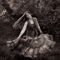 a woman twirling with a skirt